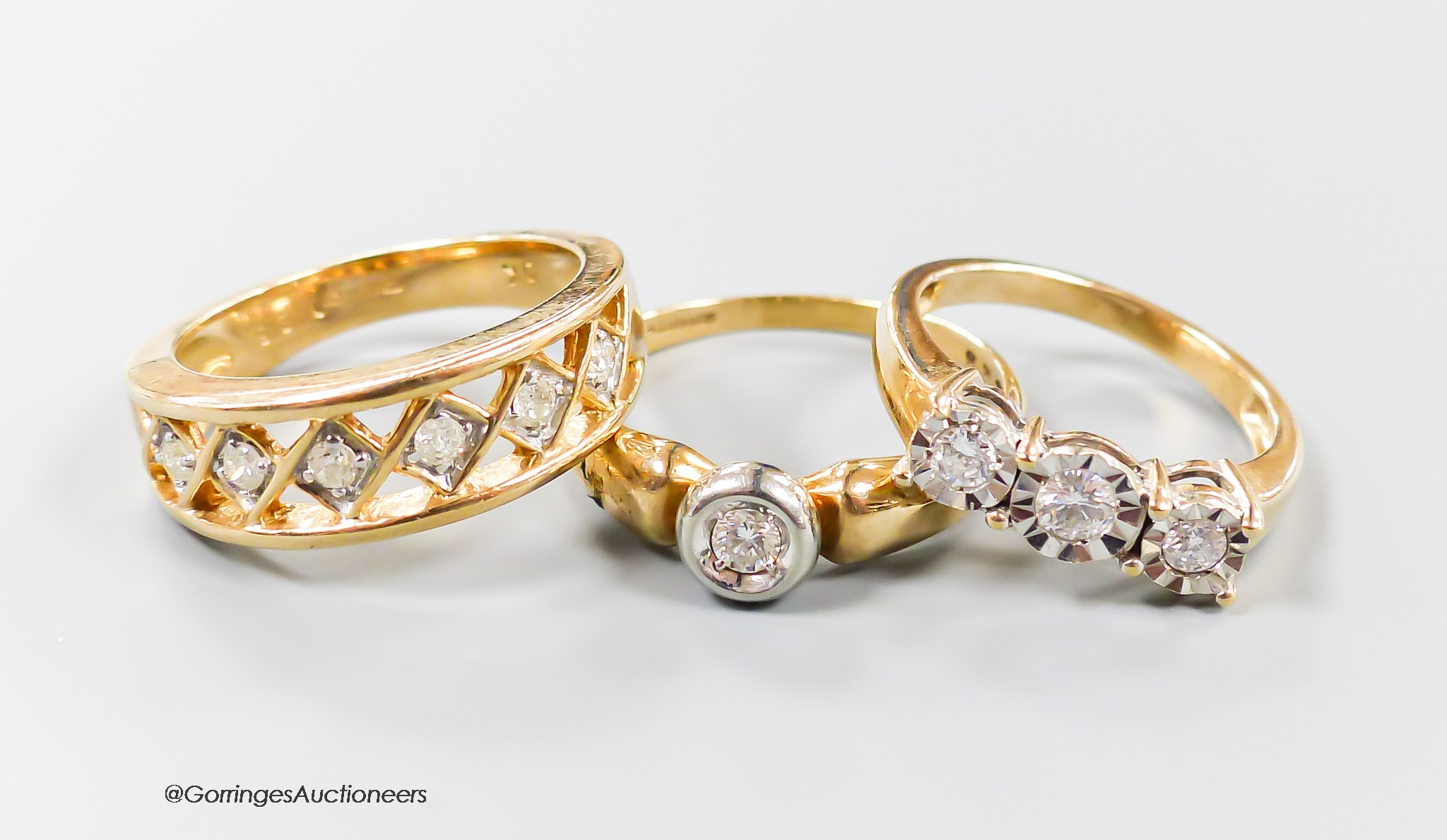 Three assorted modern 9ct gold and diamond set dress rings, including illusion set three stone and solitaire, gross weight 9.5 grams.
